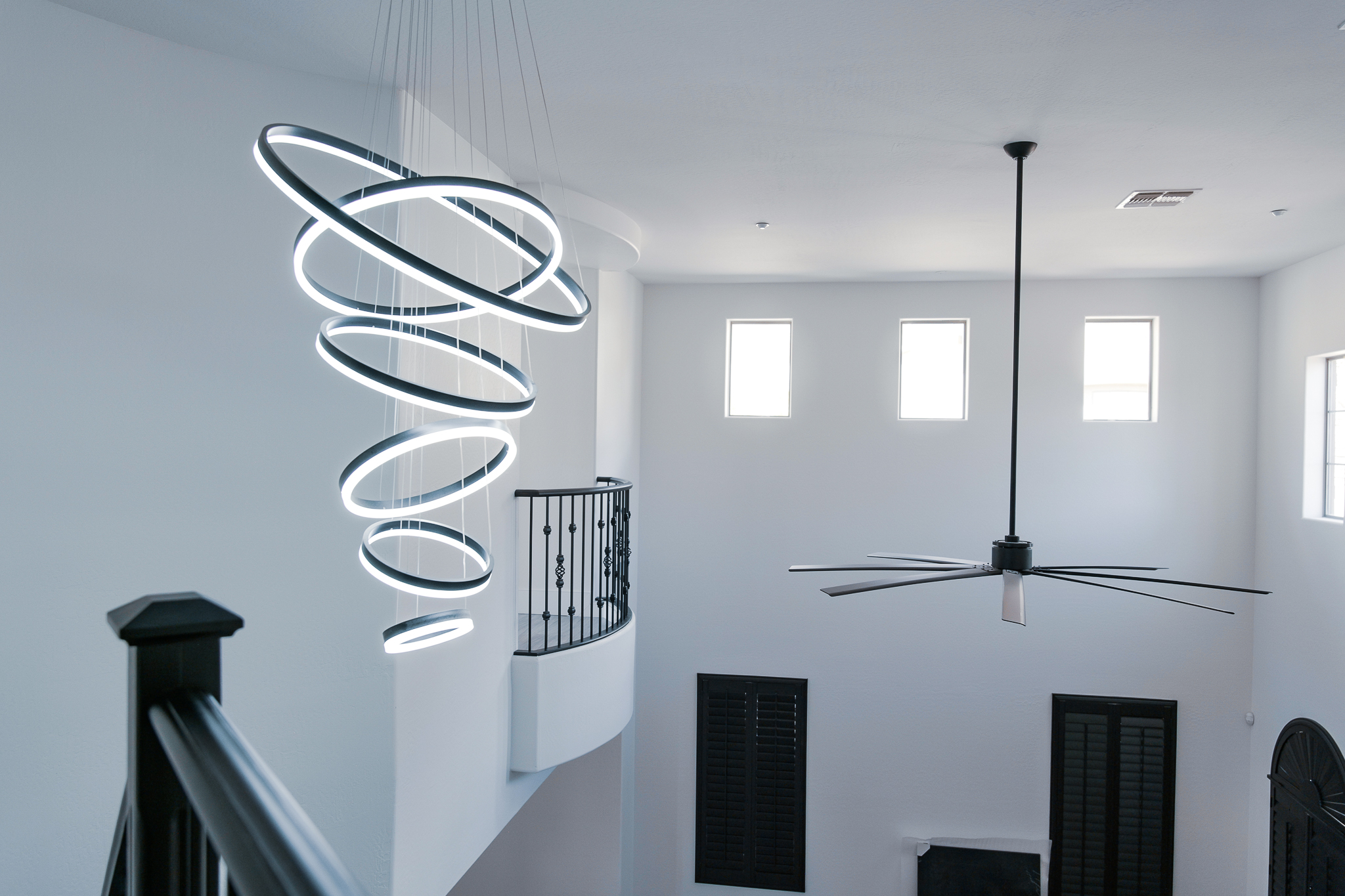 Unique spiral LED pendant light fixture with multiple illuminated rings.