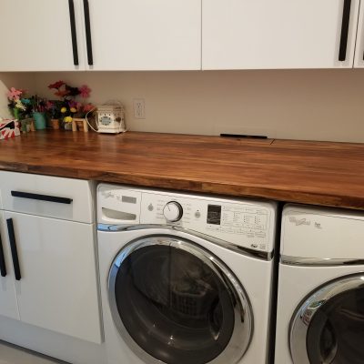 Mesa laundry room white cabinets butcher block countertop front load washer dryer