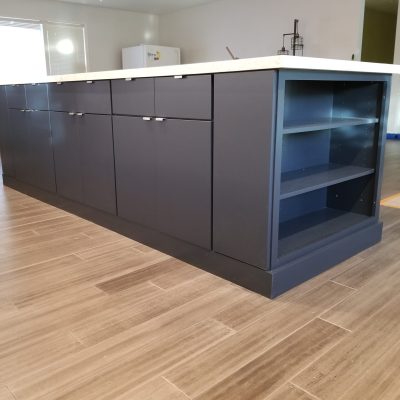 Mesa kitchen island dark gray cabinets light countertop wood-look floor