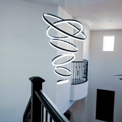 Contemporary lighting fixture with stacked LED rings in a stairwell.
